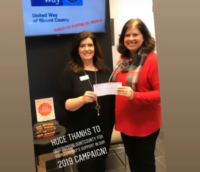 Co-Owner Andrea Pope with a representative from United Way